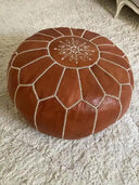 Traditional brown Moroccan leather pouf front view