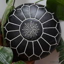 Black Moroccan leather pouf with white stitched detailing