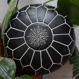 Black Moroccan leather pouf with white stitched detailing