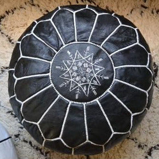 Black Moroccan leather pouf with white stitched detailing